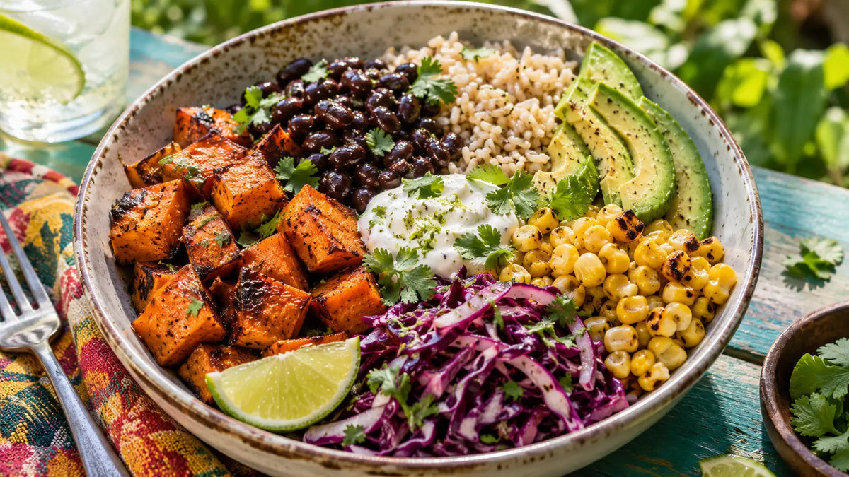 Jamaican-spiced roasted sweet potato and black bean bowl with avocado, charred corn, cabbage, rice and lime yoghurt.