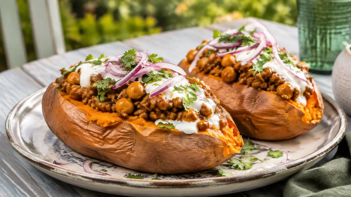 Loaded baked sweet potatoes filled with Rogan Josh lentils and chickpeas, yoghurt, red onion and coriander.