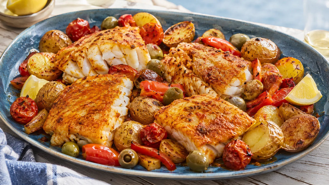 Paella-spiced cod fillets with crispy baby potatoes, roasted peppers, tomatoes, olives and lemon.