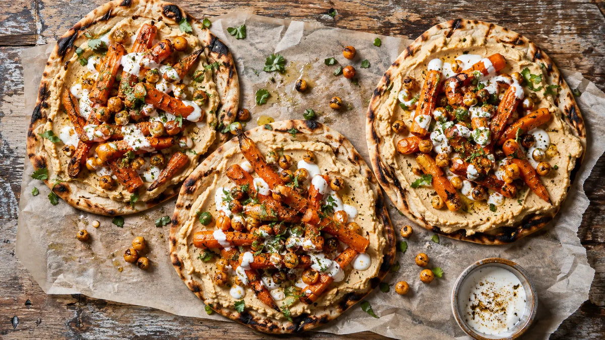 Ras El Hanout spiced carrot and hummus flatbreads with chickpeas, herbs and yoghurt drizzle.