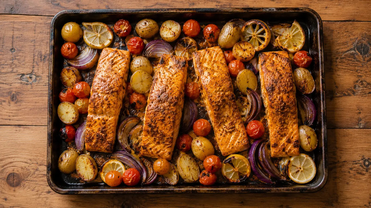 Rogan Josh-spiced salmon traybake with baby potatoes, cherry tomatoes, red onion and lemon.