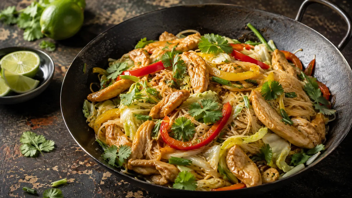 Singapore Seasoning chicken and vegetable noodles with peppers, cabbage, spring onions, coriander and lime.
