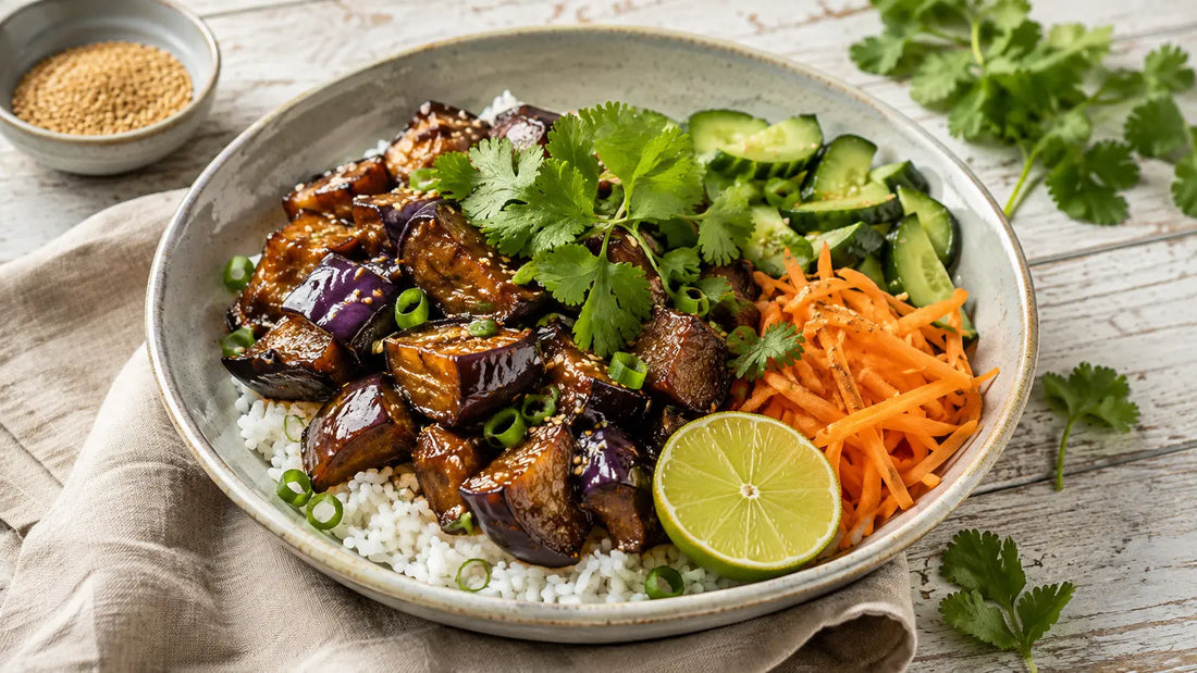 Thai Stir-Fry Spice sticky aubergine rice bowl with cucumber, carrot, spring onions, sesame seeds and lime.